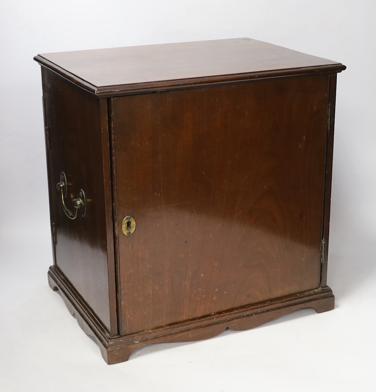 An early 19th century mahogany apothecary box, opening on both opposite sides and top lid, with fitted compartments and two drawers containing square section labelled glass bottles, oak and zinc lidded drawer sections, c